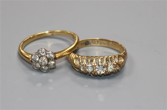 Two 18ct gold and diamond dress rings (one stone missing).